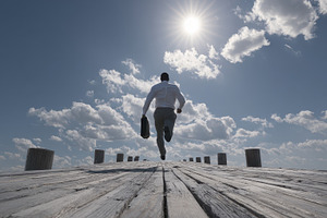 Businessman Running Towards the Sun, a Photo by Pixeness Studio