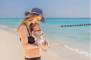 Mother holding her newborn baby by, a Person Photo by Elizaveta Galitskaya