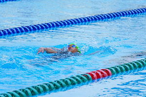 Swimmer child swims backstroke swimming style in a race swimming