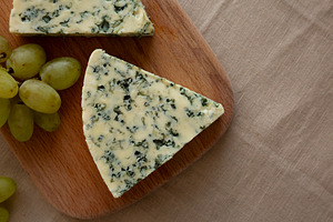 Delicious Cheese Danablu on a wooden board, top view. Copy space, a Food & Drink Photo by LiudmylaChuhunova