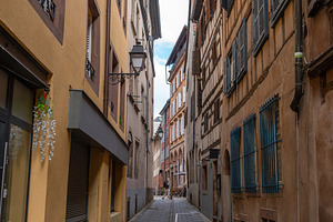 Narrow street with old houses in Strasbourg France, an Architecture Photo by GoodGoods