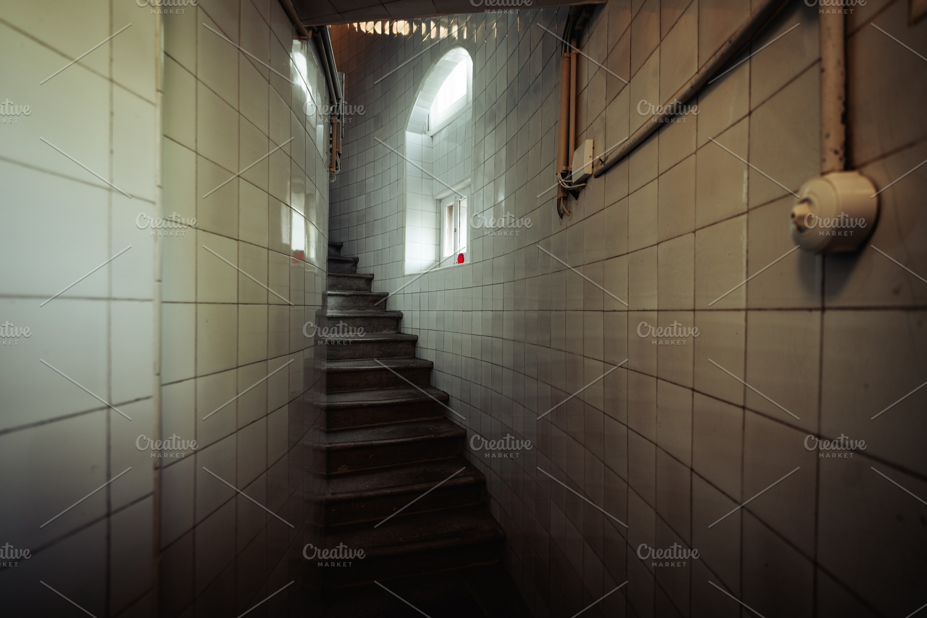 Tiled stairwell with moody light, an Architecture Photo by SkyNext