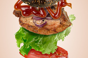 A levitating black burger with sesame seeds, a juicy fried patty, a Food & Drink Photo by ndanko