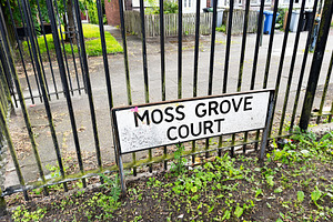 Moss Grove Court street sign on iron railings in a residential M
