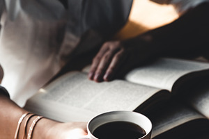 Woman reads book and drinks coffee stock photo containing background and woman