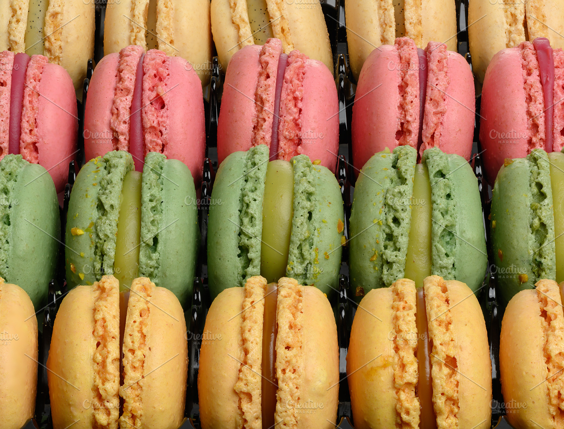 Rows of pink, green and yellow pasta laid out on a black backgro, a Food & Drink Photo by ndanko