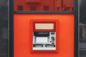 ATM in red urban wall reflection, a Business Photo by SkyNext