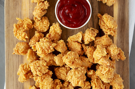 Homemade Crunchy Popcorn Chicken with Ketchup on a Board, top vi, a Food & Drink Photo by LiudmylaChuhunova