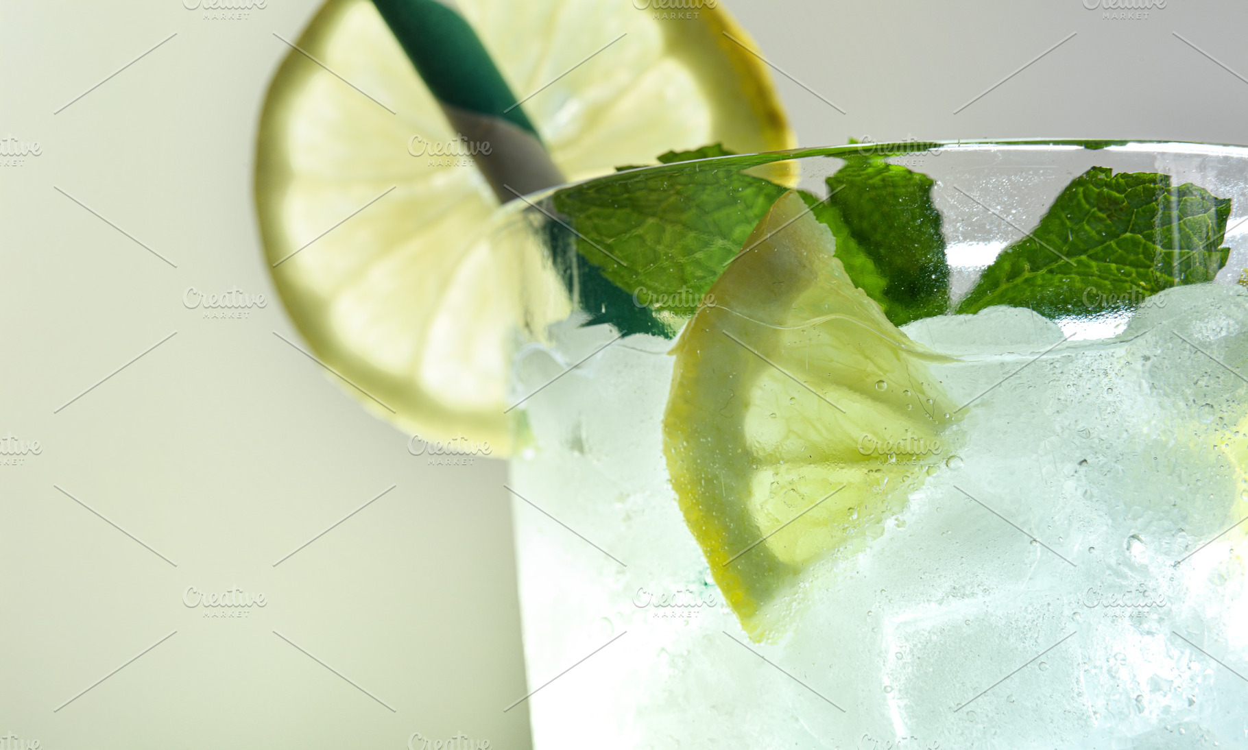 Refreshing drink with ice, mint and lemon with light background, a Food & Drink Photo by Davizro's Market