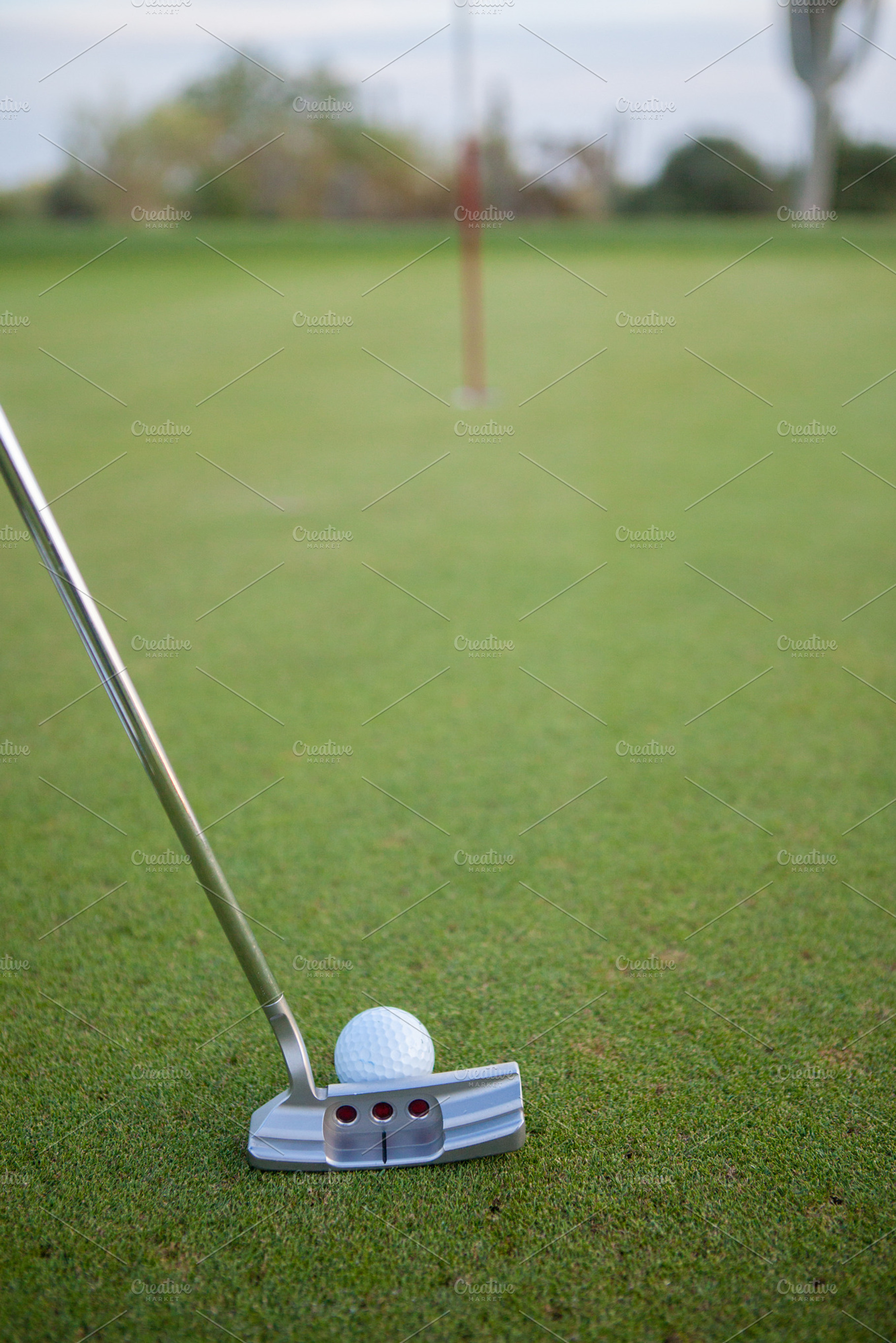Golf Ball on Green with Putter