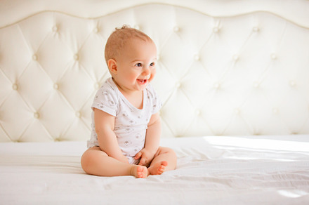 Adorable baby boy in white sunny bed, a Person Photo by Rodica Ciorba