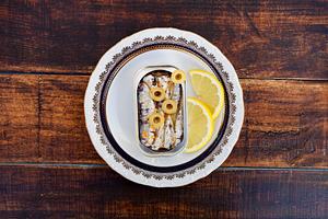 Can of canned oil sardines on a elegant plate, a Food & Drink Photo by José Manuel Gelpi