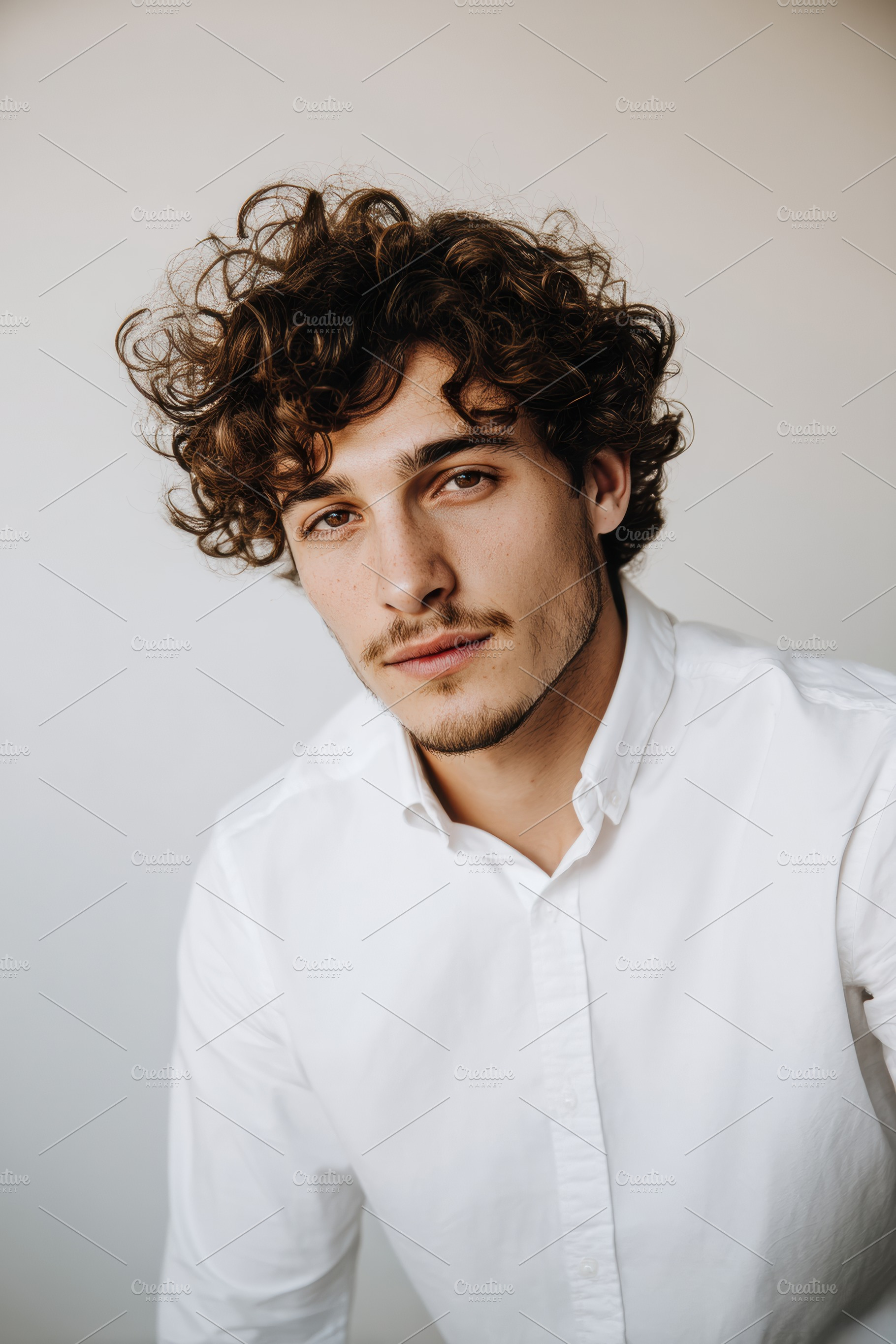Curly-Haired Man with White Shirt, a Person Photo by Virgo Studio