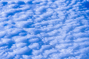 Abstract blue ice texture with snow, winter background