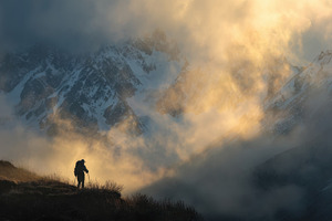 Hiker at sunset on peak, a Photo by Beautiful things