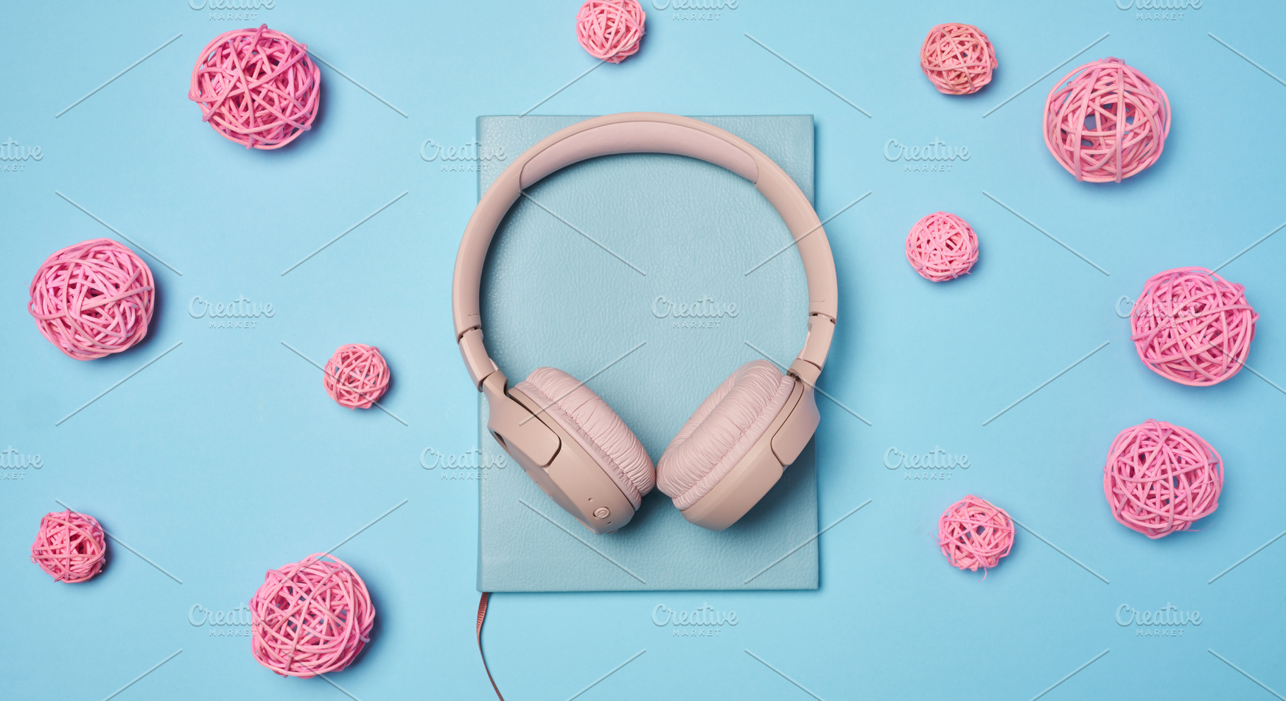 Pink wireless headphones in the center and pink decorative ratta, a Technology Photo by ndanko