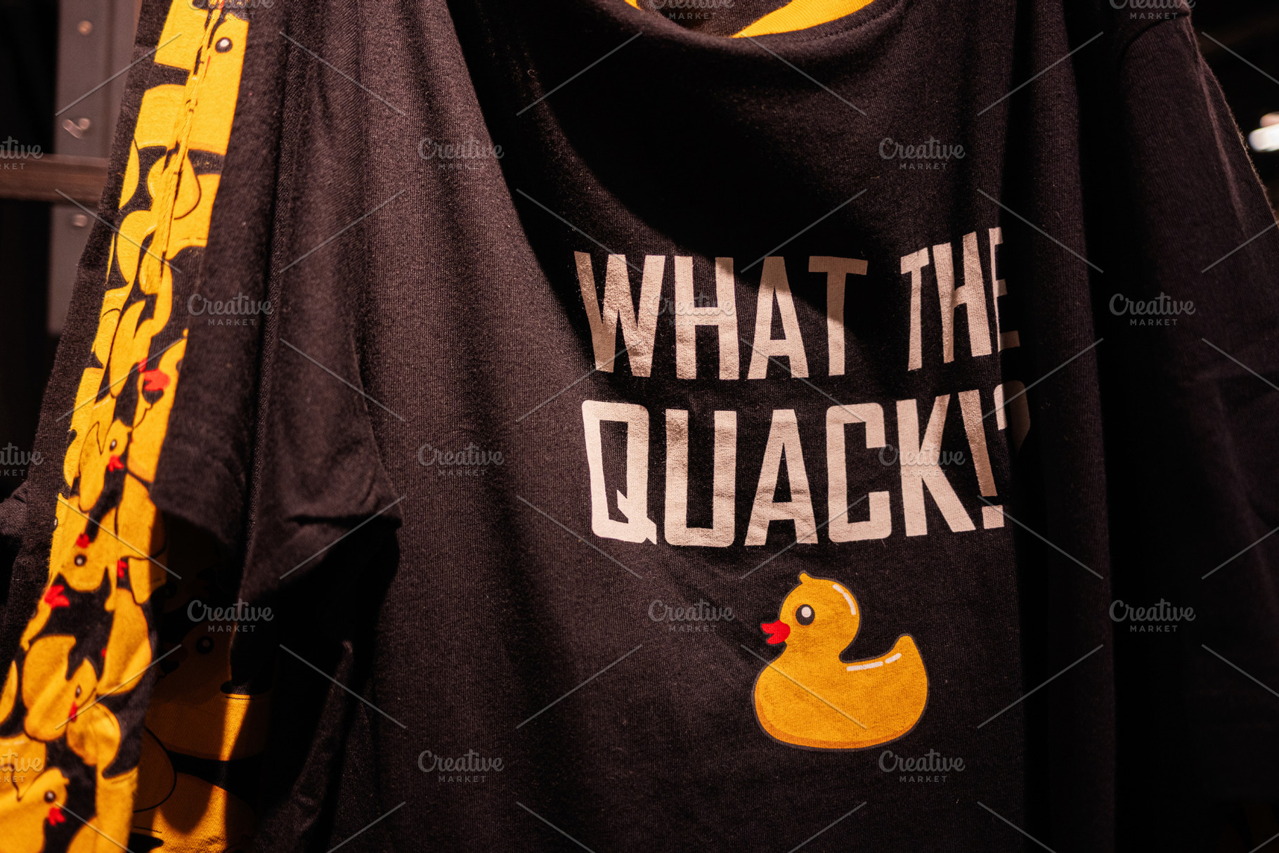 Black T-shirt with Yellow Rubber Duck Graphic and Humorous Text Design. What th, a Photo by AS photostudio