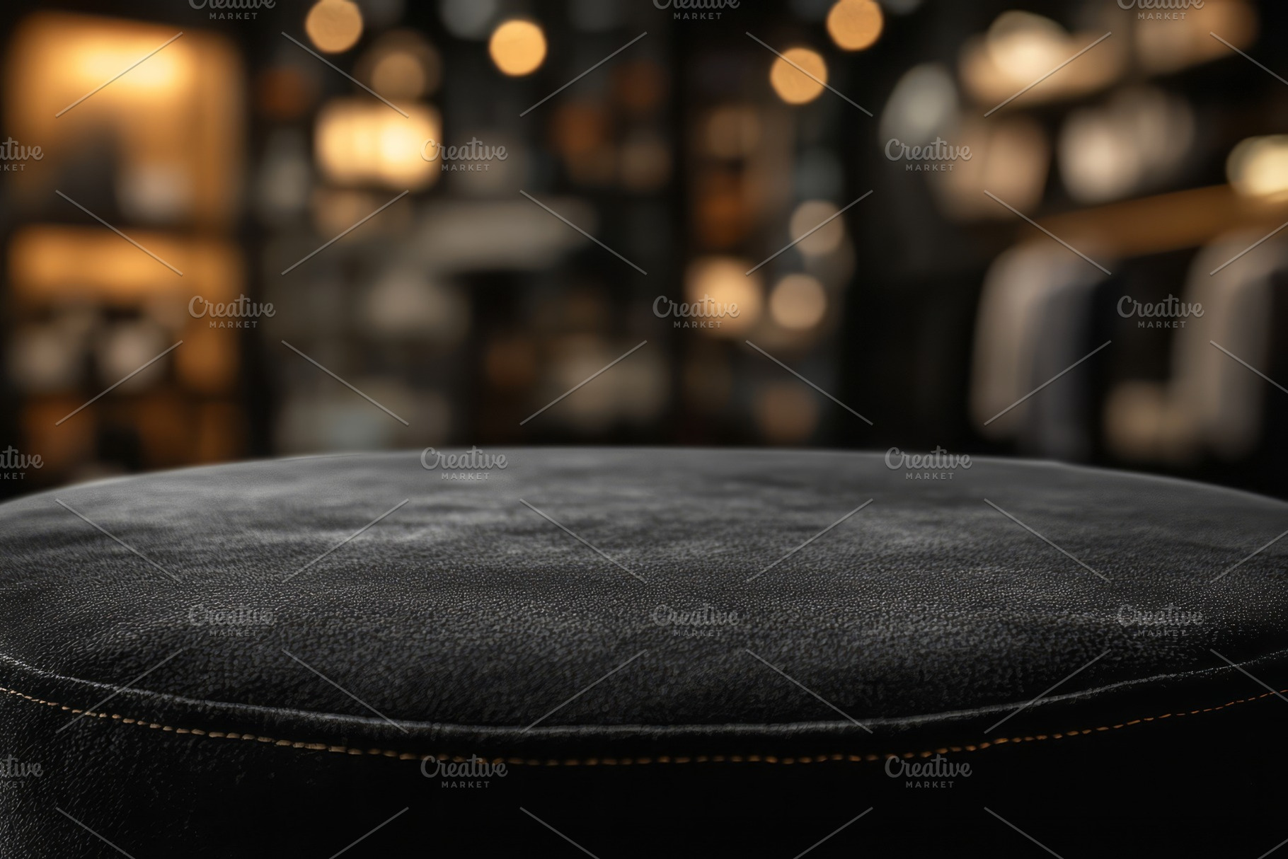 A close-up of a plush black leather ottoman with a blurred, inviting background, a Background Photo by ImageMir