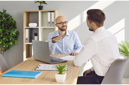 Two business men at work in office, a Business Photo by StudioRomantic