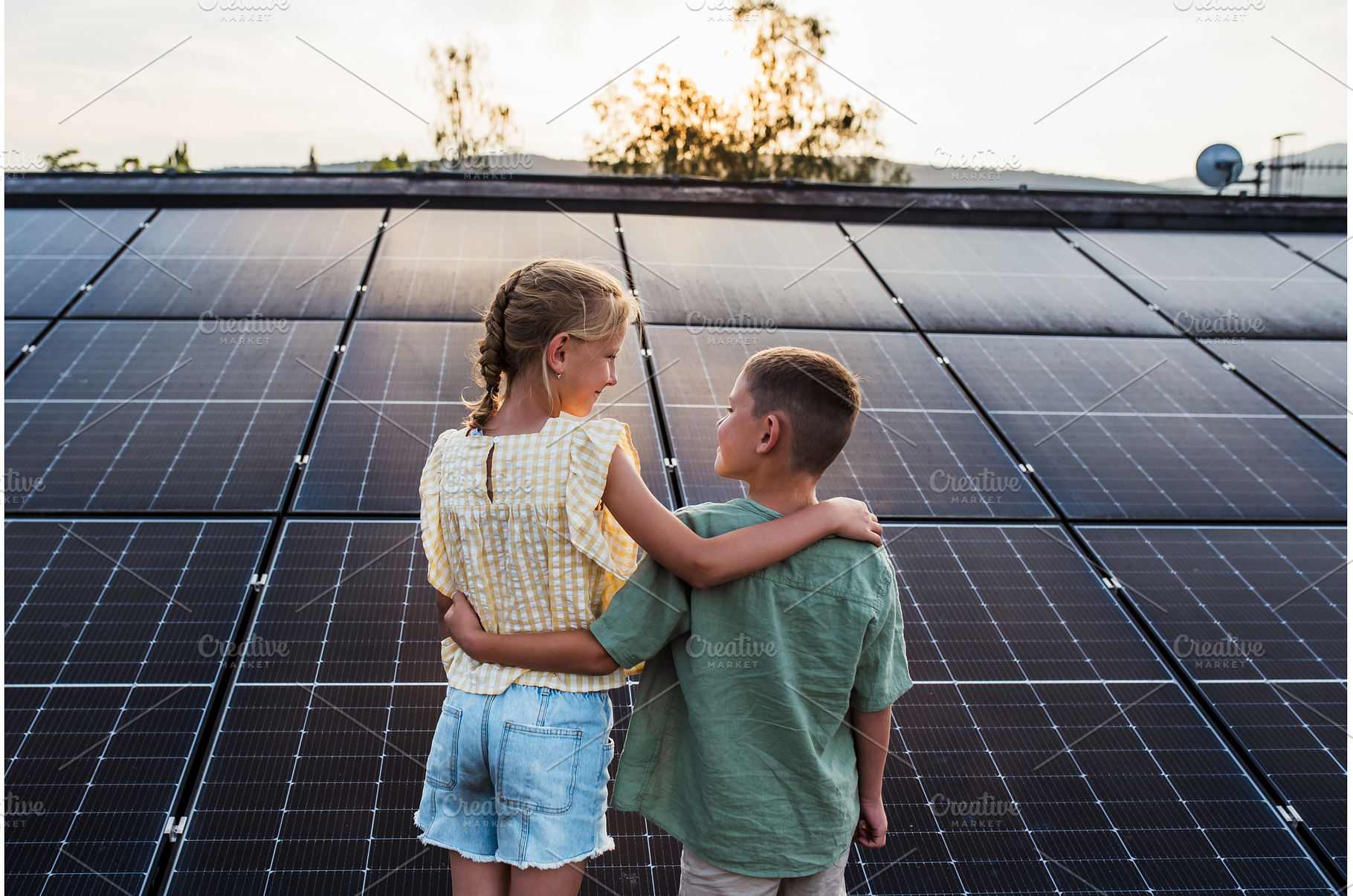 Two young siblings on roof with, a Technology Photo by HalfPoint
