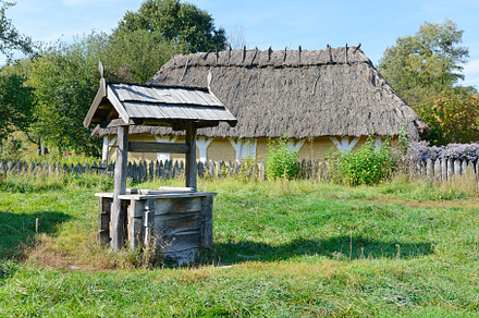 Old wooden well in the ukrainian vil containing agriculture, bucket, and bush, an Architecture Photo by Serg64