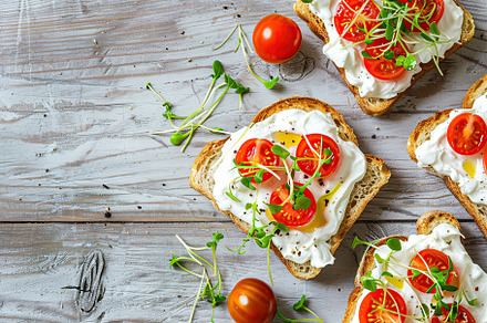 Sandwich with cream cheese, microgreens and tomatoes on wooden table, a Food & Drink Photo by AlyaAnd
