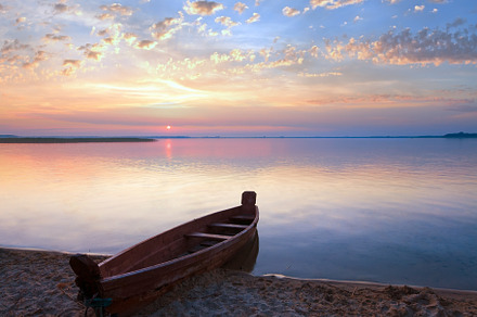 Sunset with boat near the summer lake shore, a Nature Photo by YuriyB