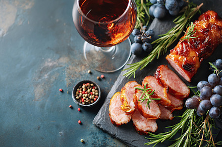 Charcuterie board layout featuring sliced meats, herbs, and a glass of drink on, a Food & Drink Photo by AlyaAnd