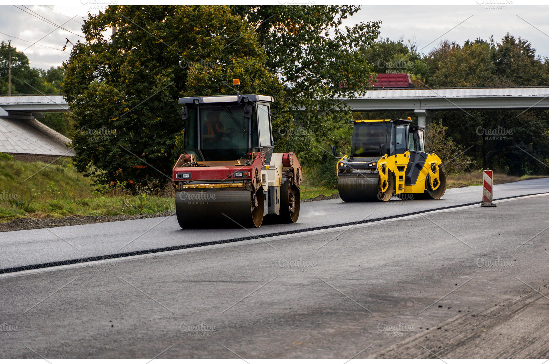 Two heavy asphalt road roller with, an Industrial Photo by volodymyrshtun13795