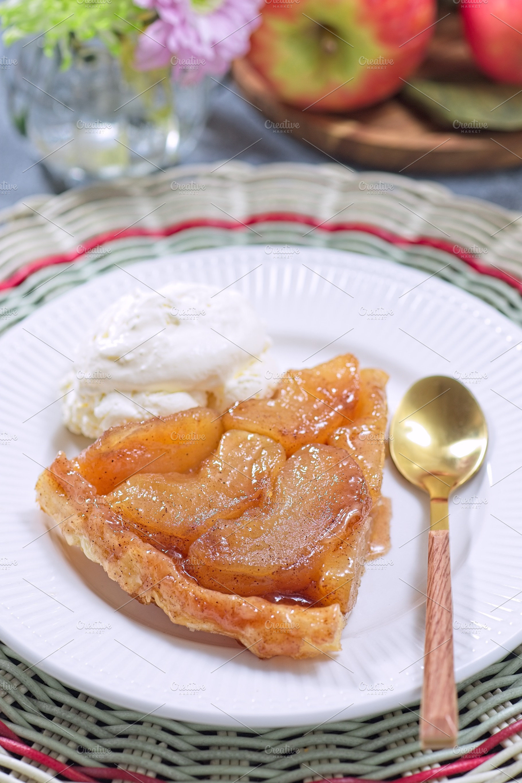 Slice of delicious apple tarte tatin with scoop of whipped cream, french upside, a Food & Drink Photo by iuliia_n