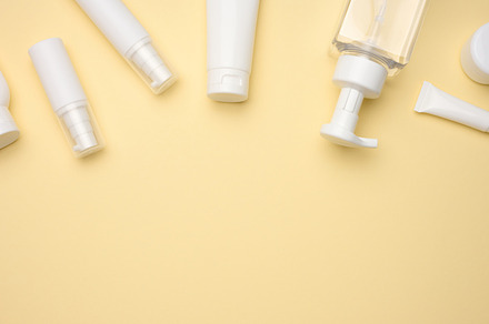 top view of white cream tubes, cosmetic dispenser, empty jars an, a Beauty & Fashion Photo by ndanko