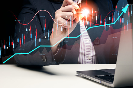 Woman sits at a laptop in front of a holographic chart with grow, a Business Photo by ndanko