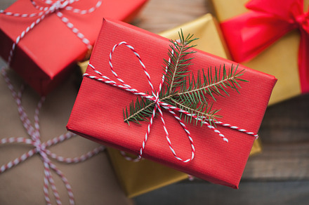 Christmas background with gift boxes on wooden background top view, a Holiday Photo by Budarinphoto