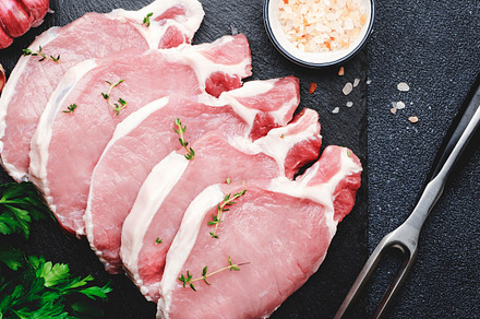 Raw pork chops, meat on slate board prepared for cooking with ga, a Food & Drink Photo by 5PH