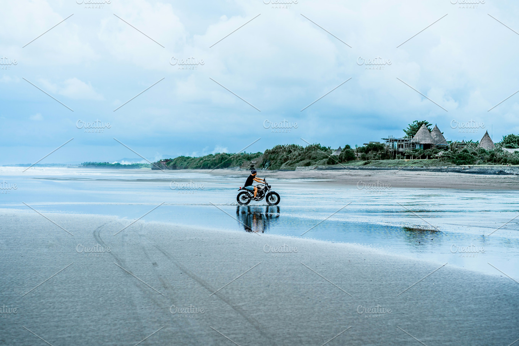Man on a motorcycle on the ocean stock photo containing motorcycle and couple, a Transportation Photo by EVA.studio