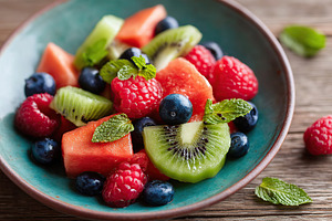 Refreshing summer fruit salad featuring kiwi, berries, and melon for a healthy, a Food & Drink Photo by AlyaAnd