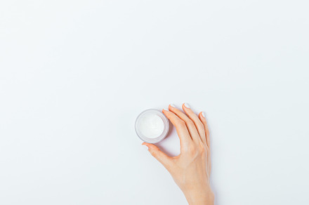 Small jar of cosmetic face cream in female hand, a Beauty & Fashion Photo by progressman
