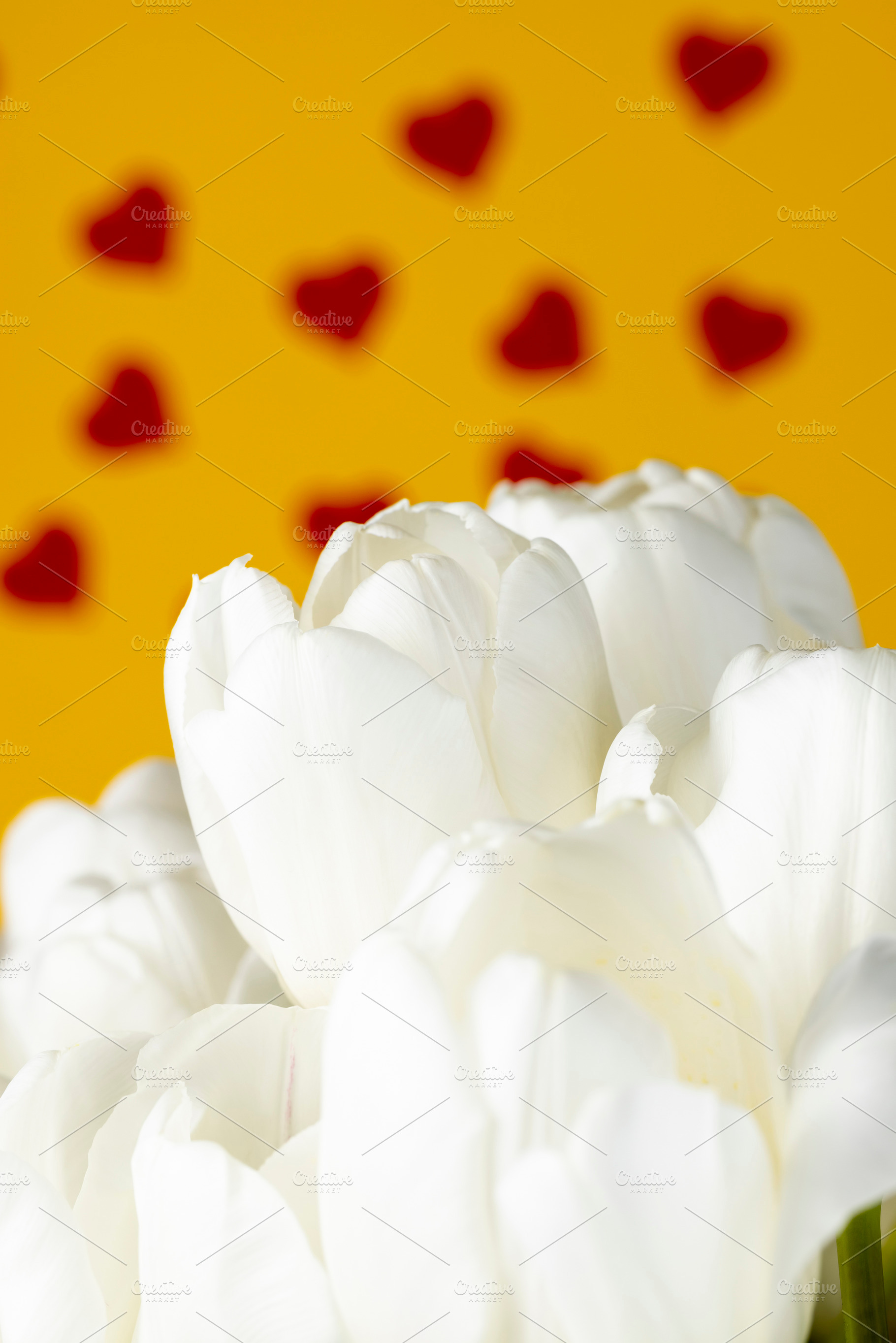 red hearts and white tulip flowers pasted on yellow paper, closeup, a Photo by rsoollAI