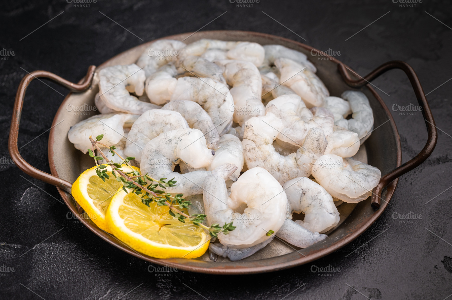 Raw peeled shrimp prawn with lemon and thyme in a metal pan on a, a Food & Drink Photo by composter-box@mail.ru