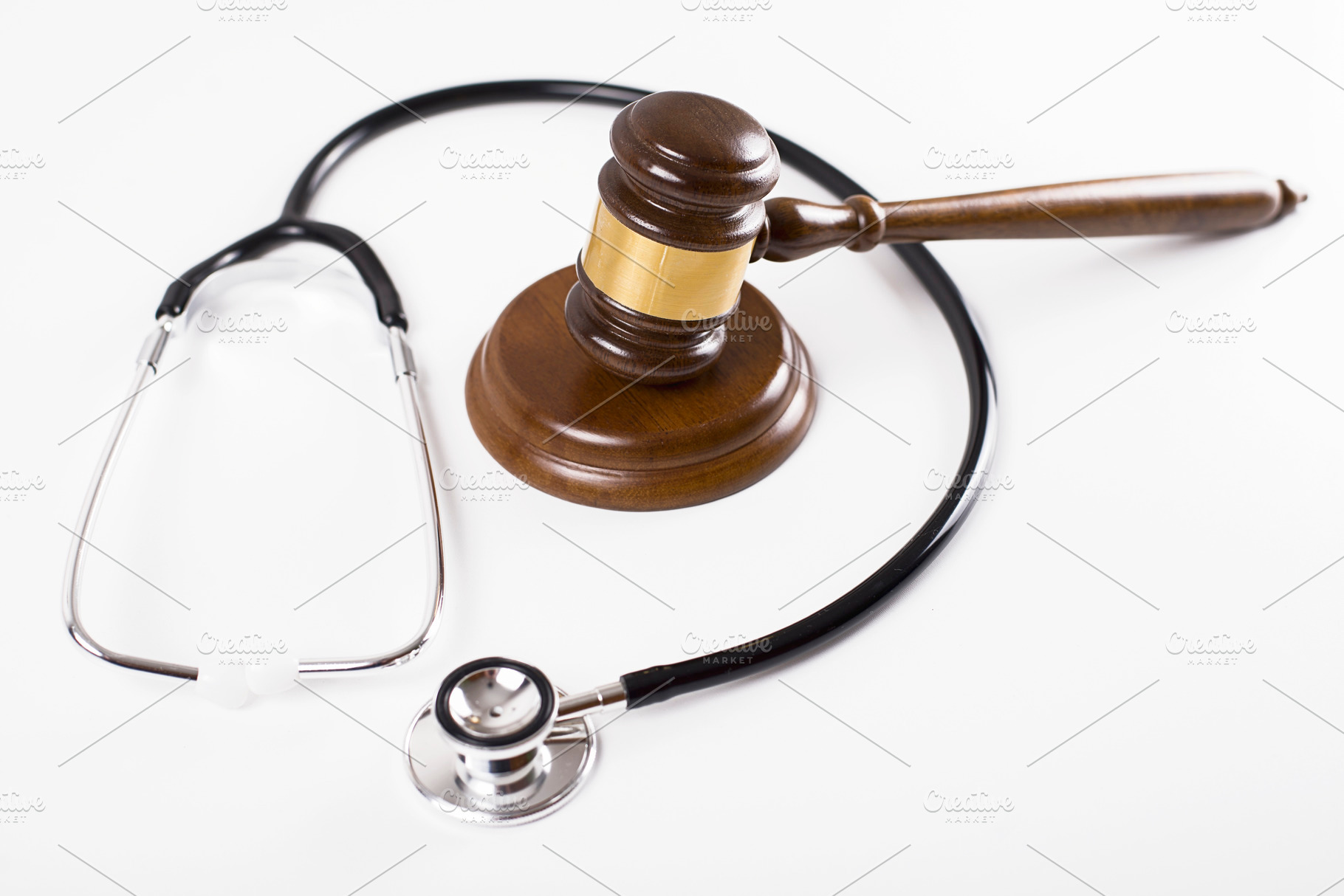 Judge gavel next to stethoscope on white background. Isolated. Medical negligence concept., a Health & Medical Photo by José Luis Agudo