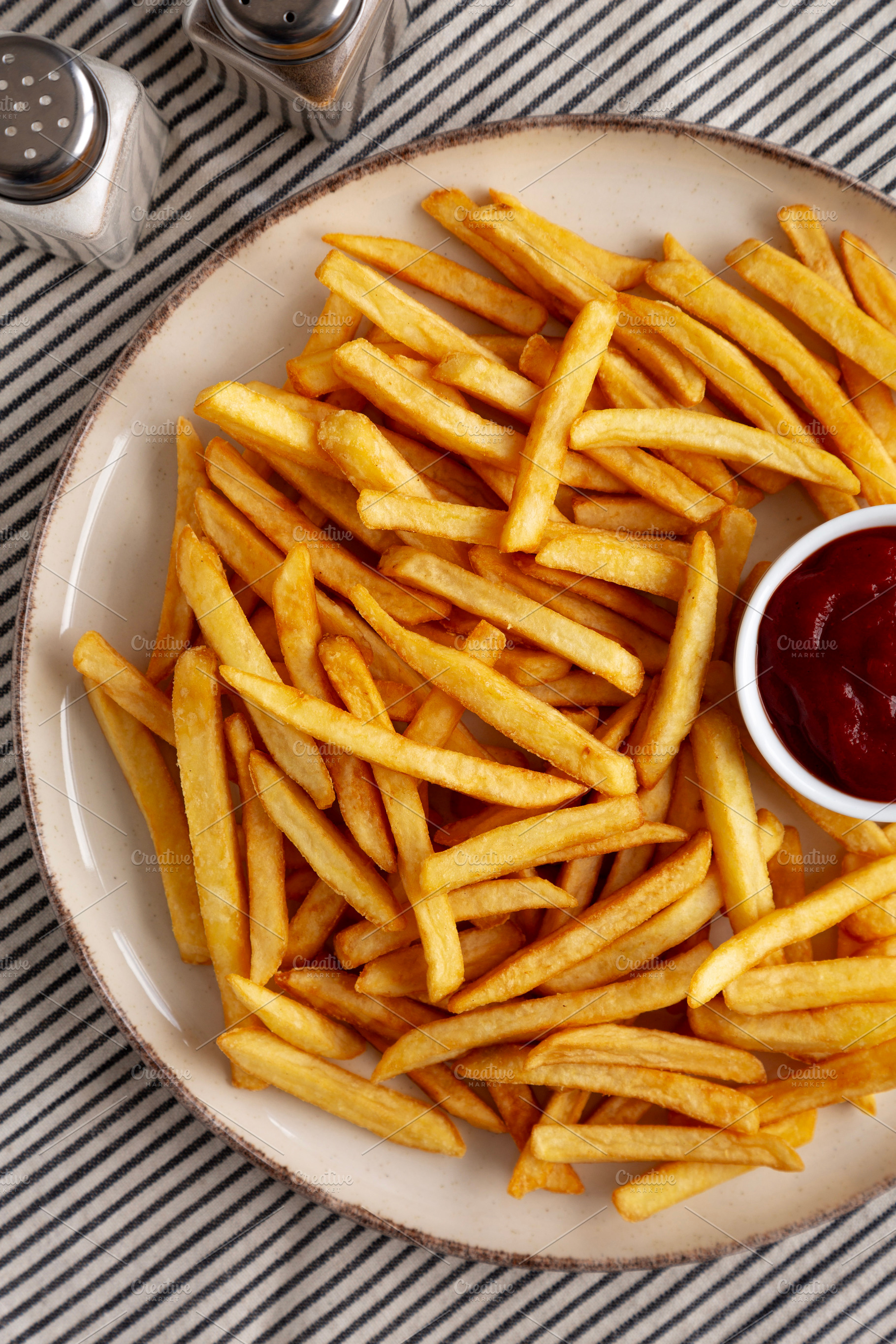 Homemade Golden French Fries with Ketchup, top view., a Food & Drink Photo by LiudmylaChuhunova