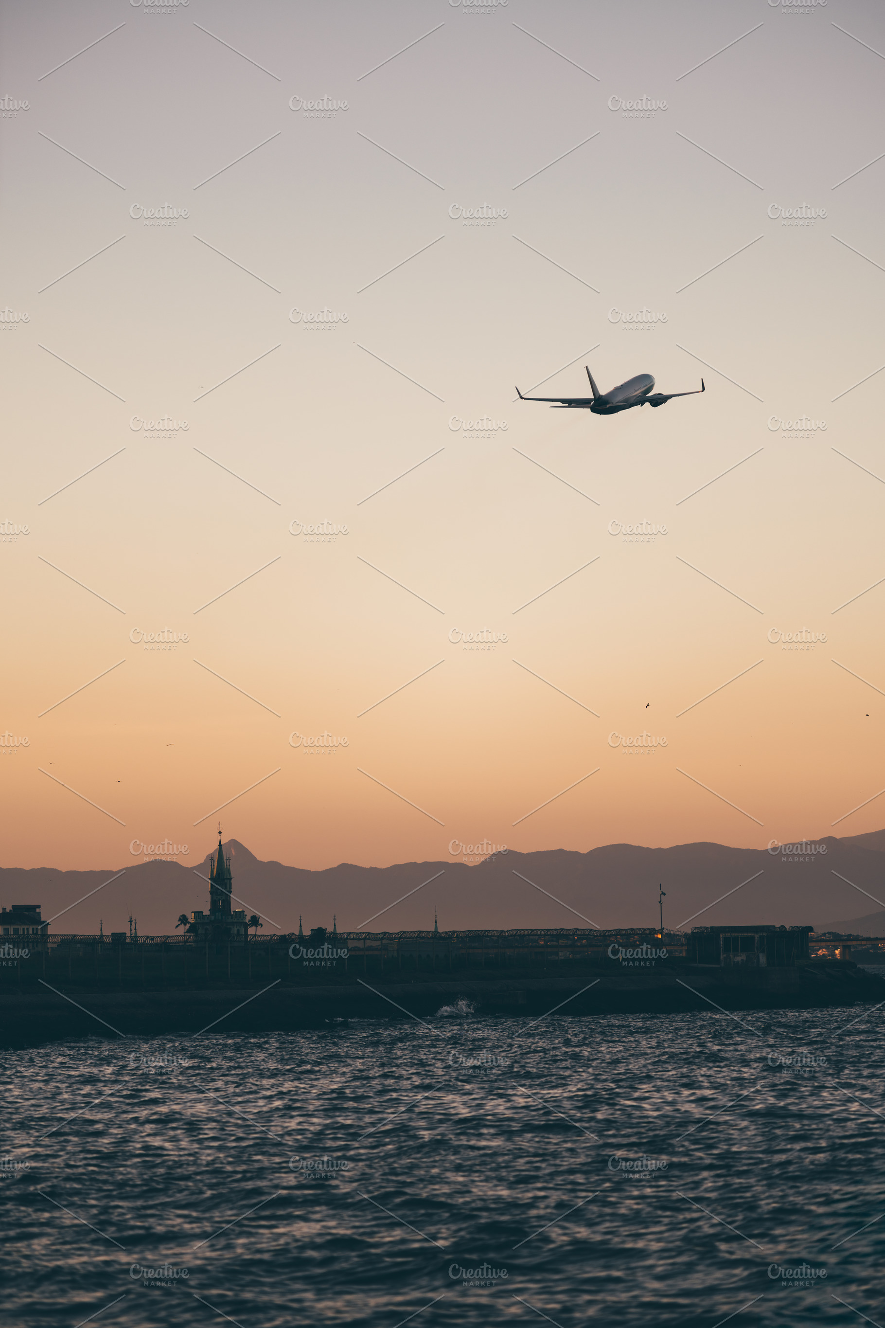 Jet over sea at sunset sky, a Transportation Photo by SkyNext