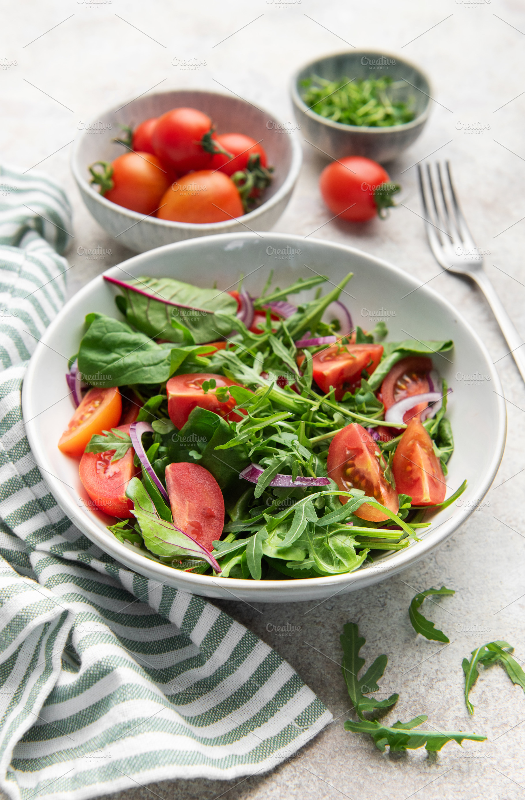 Fresh green salad with tomatoes and red onion, a Photo by Olena Rudo