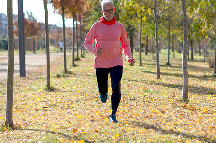 Senior man running outdoors in sportswear