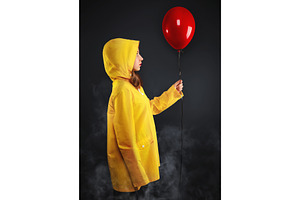 Sad little girl in haze yellow coat.
