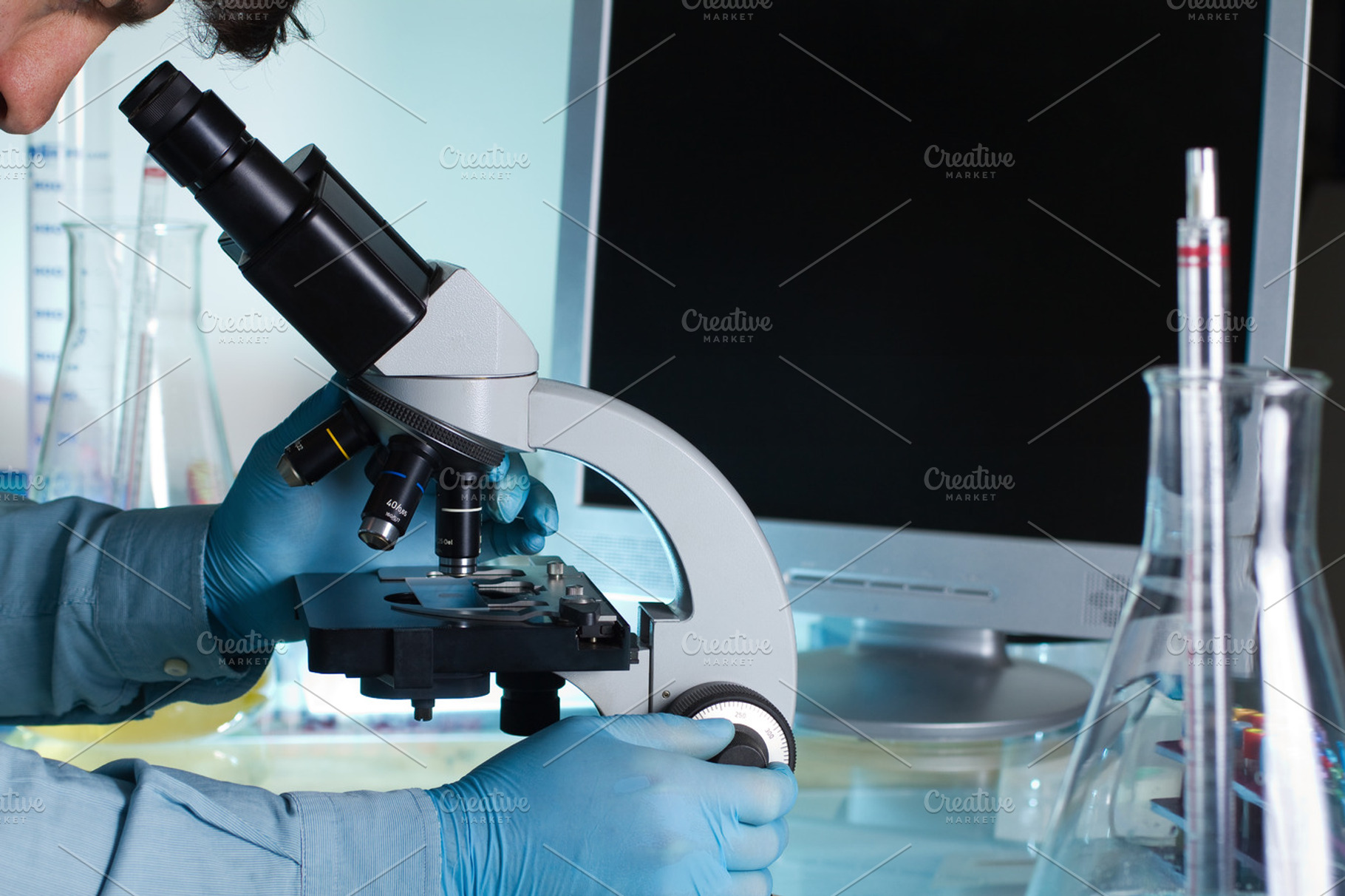 Researcher looking at a sample under, a Health & Medical Photo by angellodeco