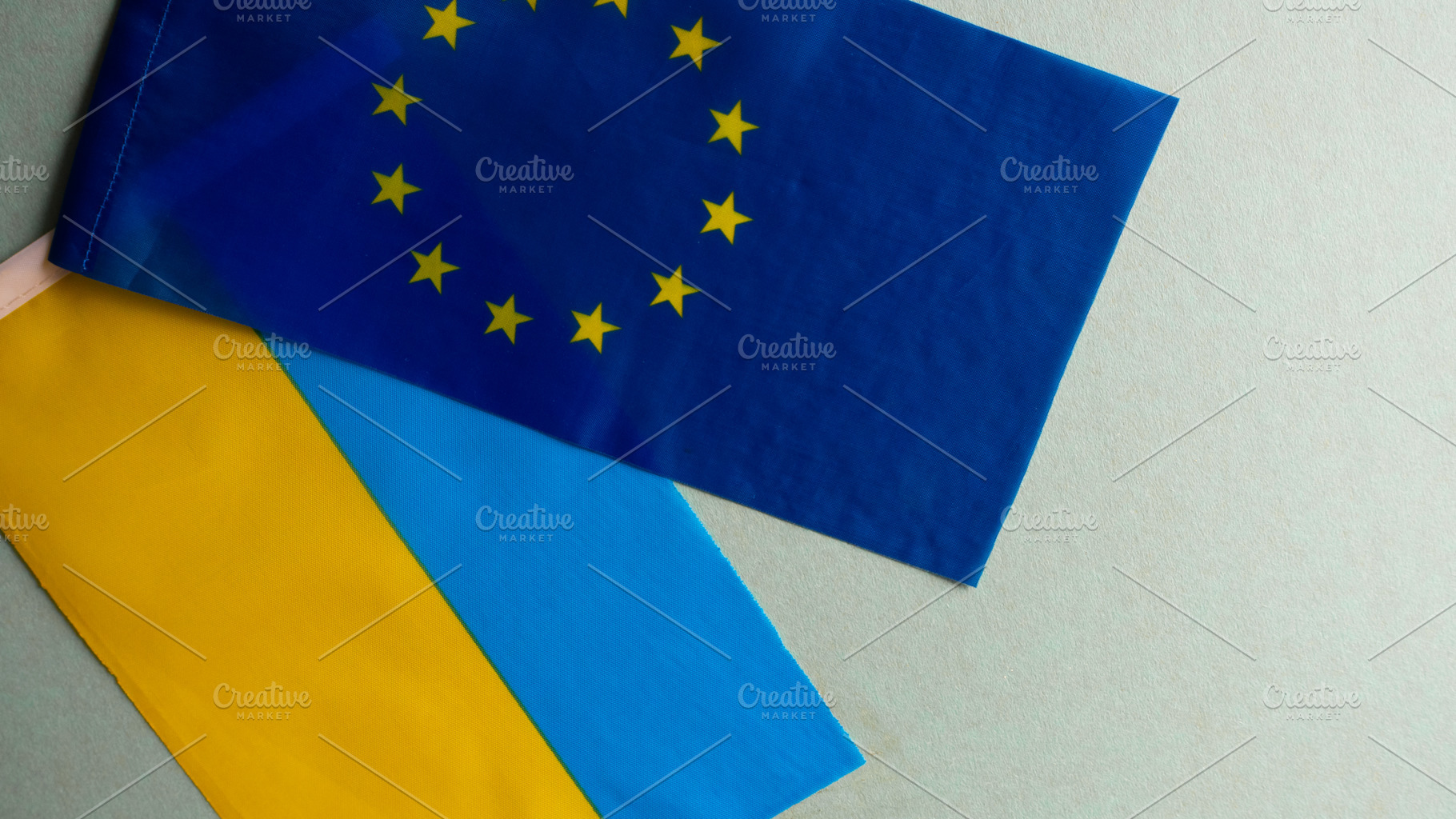 European union and Ukraine two folded silk flags together, a Background Photo by OleksandrRybitskyi