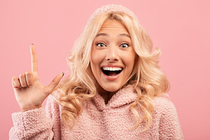 Great idea concept. Excited lady having wow creative idea, raising finger up or, a Photo by Prostock-Studio