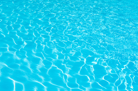 Water surface on swimming pool featuring surface, sunlight, and ripples, an Abstract Photo by PranFoto