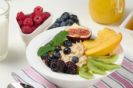 full plate with oatmeal and fruit, freshly squeezed juice in a t, a Food & Drink Photo by ndanko